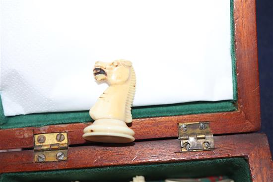 A small Staunton type ivory chess set, in mahogany box, kings 2.5in., missing one red pawn and the red king